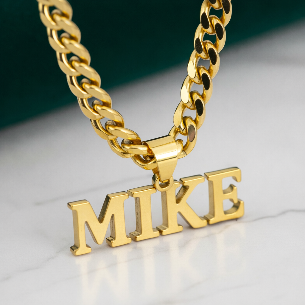 Gold chain necklace with 'MIKE' pendant on a reflective surface - My Keepsake Story